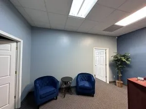 Gray office interior painting with navy accent chairs