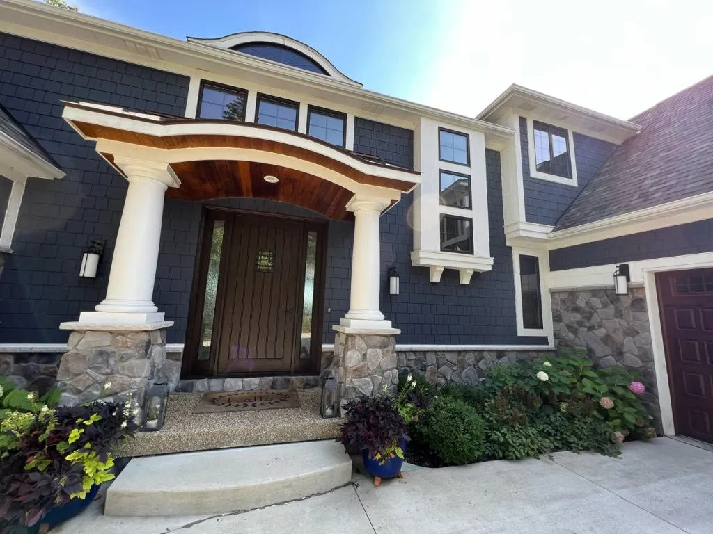 Dark exterior paint finish on Michigan home with stone accents