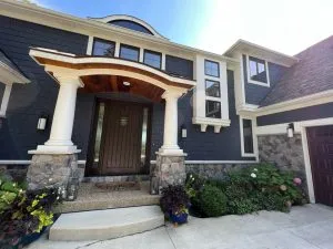 Dark exterior paint finish on Michigan home with stone accents