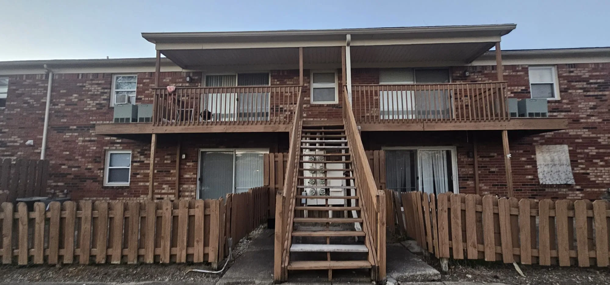 Exterior painting of apartment building with wood deck