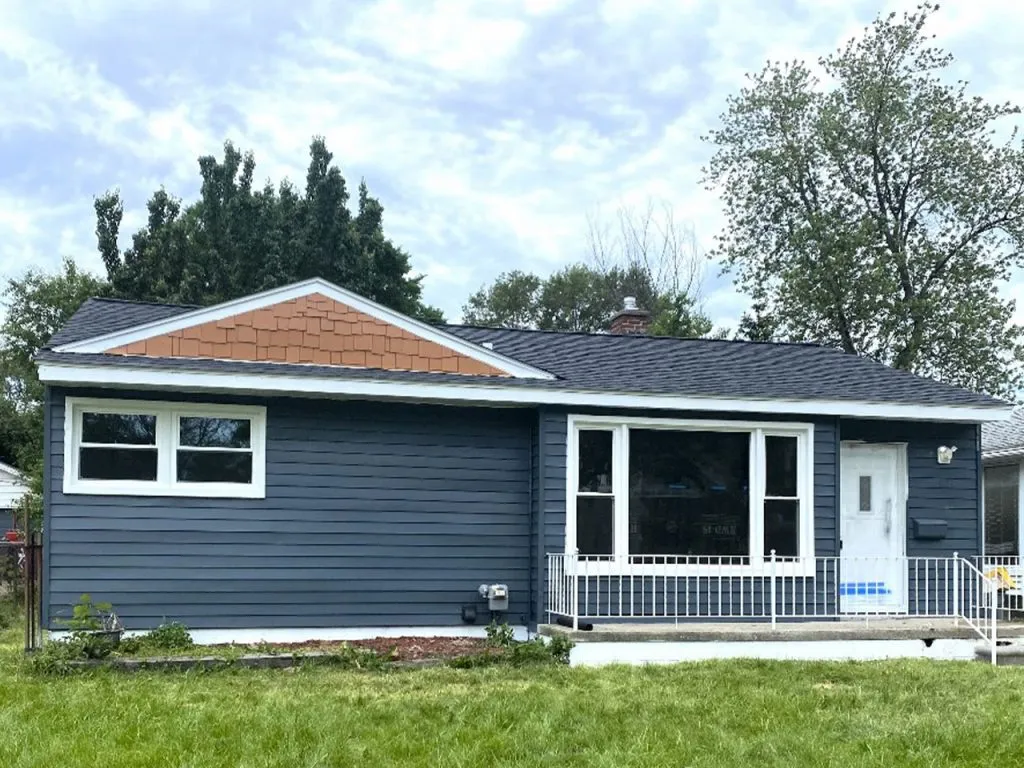 "Freshly painted dark gray house exterior with white trim"