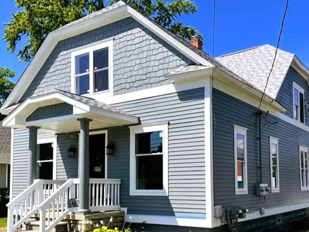 12. "Freshly painted gray house exterior with white porch trim"
