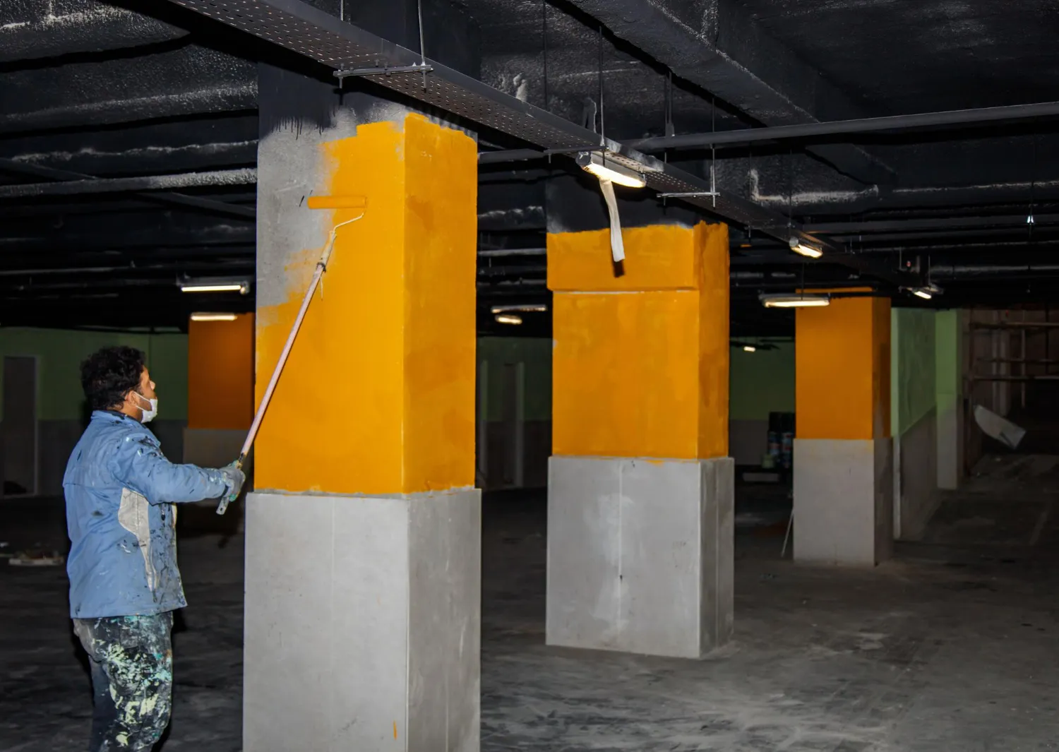 Freshly painted yellow support pillars in parking garage