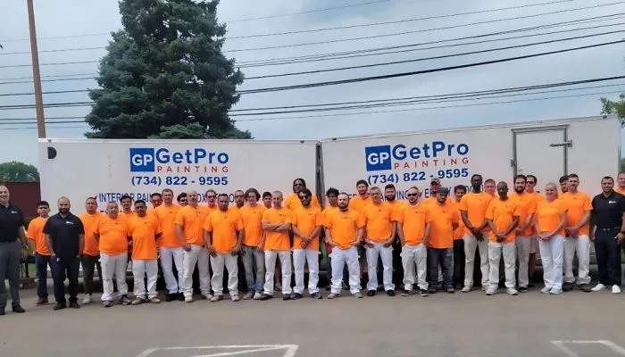 Get Pro Painting crew group photo in orange branded uniforms